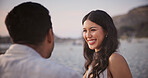 Love, woman and couple at beach with smile, romantic moment and bonding together on summer holiday. Care, partner and people with security, tender connection and happy relationship on outdoor trip.