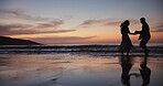 Silhouette, couple and dancing at beach for travel, celebration and romantic date on holiday. Space, sunset and people at seashore with smile, commitment and tropical vacation for adventure getaway