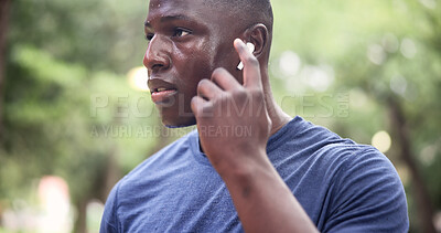 Buy stock photo Earphones, fitness and runner with black man in park for workout playlist, health and exercise break. Streaming service, training podcast and wellness with person in nature for music and audio