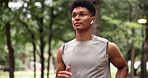 Running, fitness and man with earphones for exercise, serious or physical activity with subscription. Outdoor, athlete and person with technology for workout, endurance and listening to music at park