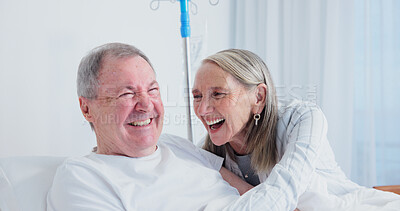 Buy stock photo Senior, laughing and happy couple with hospital visit for healthcare, funny joke or humor together. Elderly, man and woman with smile or hug in bed for comedy, support or trust in medical facility