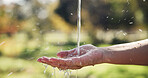 Nature, water and person washing hands outdoor for hygiene, sanitation and grooming with self care. Wellness, health and cleaning skin in park for removal of dirt, germs or bacteria in countryside.