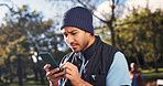 Confused, man and volunteer at park with phone, wrong location and distribution error for charity. Unsure, male person and mobile in nature for outreach, incorrect donation and website glitch for ngo