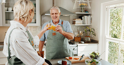 Buy stock photo Cooking, cheers and mature couple with juice in kitchen for help, bonding or meal prep in home. Marriage, happy and man with woman toast with drink to prepare dinner, supper or lunch for relationship