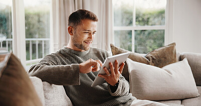 Buy stock photo Man, tablet and smile on sofa for social media, communication or entertainment in home living room. Male person, typing and relax on lounge couch with technology for online streaming and search