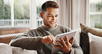 Tablet, smile and man on sofa in home with texting, communication or social media on app in living room. Happy, relax and person with digital technology for online chatting for contact in apartment.