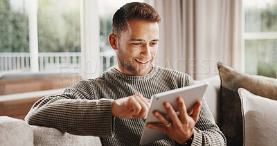 Buy stock photo Tablet, smile and man on sofa in home with texting, communication or social media on app in living room. Happy, relax and person with digital technology for online chatting for contact in apartment.
