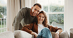 Hug, smile and portrait of couple on sofa in home for bonding, love and connection in marriage. Happy, care and man embracing woman in living room for commitment, relax or safety in apartment.