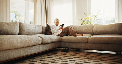 Buy stock photo Relax, sofa and senior woman with phone, social media and online chat for internet connection. Retirement, home and person on cellphone for communication, digital puzzle and website in living room