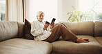 Phone, sofa and senior woman with credit card, online shopping and digital purchase on website. Retirement, home and happy person with bank info for payment, checkout and subscription for ecommerce