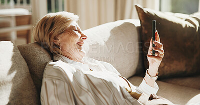 Buy stock photo Laugh, home and senior woman with phone, social media and funny message for internet connection. Retirement, sofa and happy person on cellphone for contact, online humor and website in living room