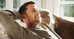 Relax, home and break with happy man on sofa for holiday rest, lazy summer or free time. Calm, male person or homeowner thinking with smile on living room couch for weekend vacation or plan in house