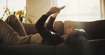 Relax, sofa and woman in morning with phone, social media and check notification for message. Home, weekend and person on cellphone for internet, website and mobile app for communication on couch
