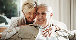 Hug, happy and couple on sofa in home for bonding, love and connection in marriage on weekend. Smile, care and mature woman embracing man in living room for commitment, relax or safety in apartment.