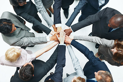 Buy stock photo Above, huddle and business people in studio with hands together, diversity or unity for collaboration. Employees, teamwork and solidarity for corporate goals, synergy and support on white background.
