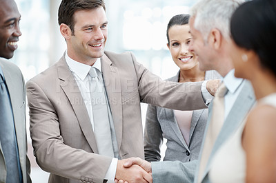 Buy stock photo Corporate, team and smile with handshake in office for company merger, business partners or b2b. Shareholders, happy people or shaking hands for acquisition deal, joint venture or negotiation success