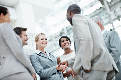 Buy stock photo Business, team and happy handshake in office building for staff welcome, onboarding and growth. Low angle, people and shaking hands with new hire for first day, internship opportunity and integration