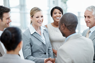 Buy stock photo Team, woman and happy with handshake in office building for staff welcome, onboarding and growth. Smile, people and shaking hands with new hire for first day, internship opportunity and integration