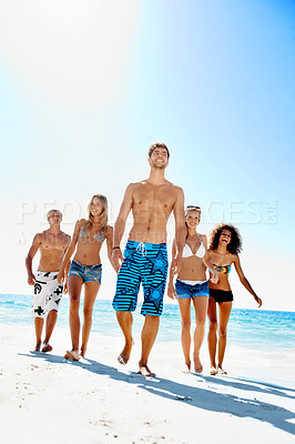 Buy stock photo Walking, travel and holiday with friends at beach for summer vacation, support and freedom. Tropical getaway, connection and adventure with group of people outdoor for tourism, space and smile
