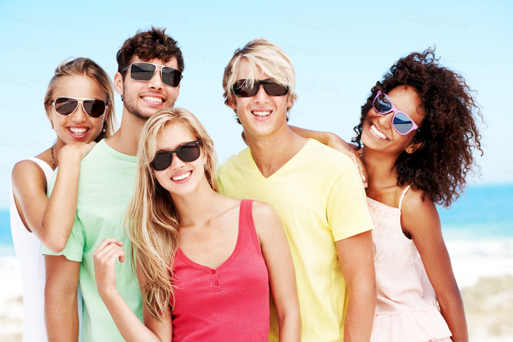 Buy stock photo Sunglasses, portrait and travel with friends at beach for summer vacation, bonding and smile together. Tropical getaway, tourism and weekend break with group of people outdoor for social reunion