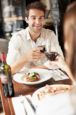 Buy stock photo Man, couple and cheers in restaurant with red wine, anniversary date and milestone for commitment. Happy people, romantic relationship and toast at lunch with alcohol beverage, celebration and love.