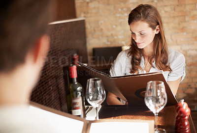 Buy stock photo Woman, couple and menu in restaurant with lunch date, meal choice and bonding on weekend break. People, romantic relationship and check dining options with order decision, wine list or relax together