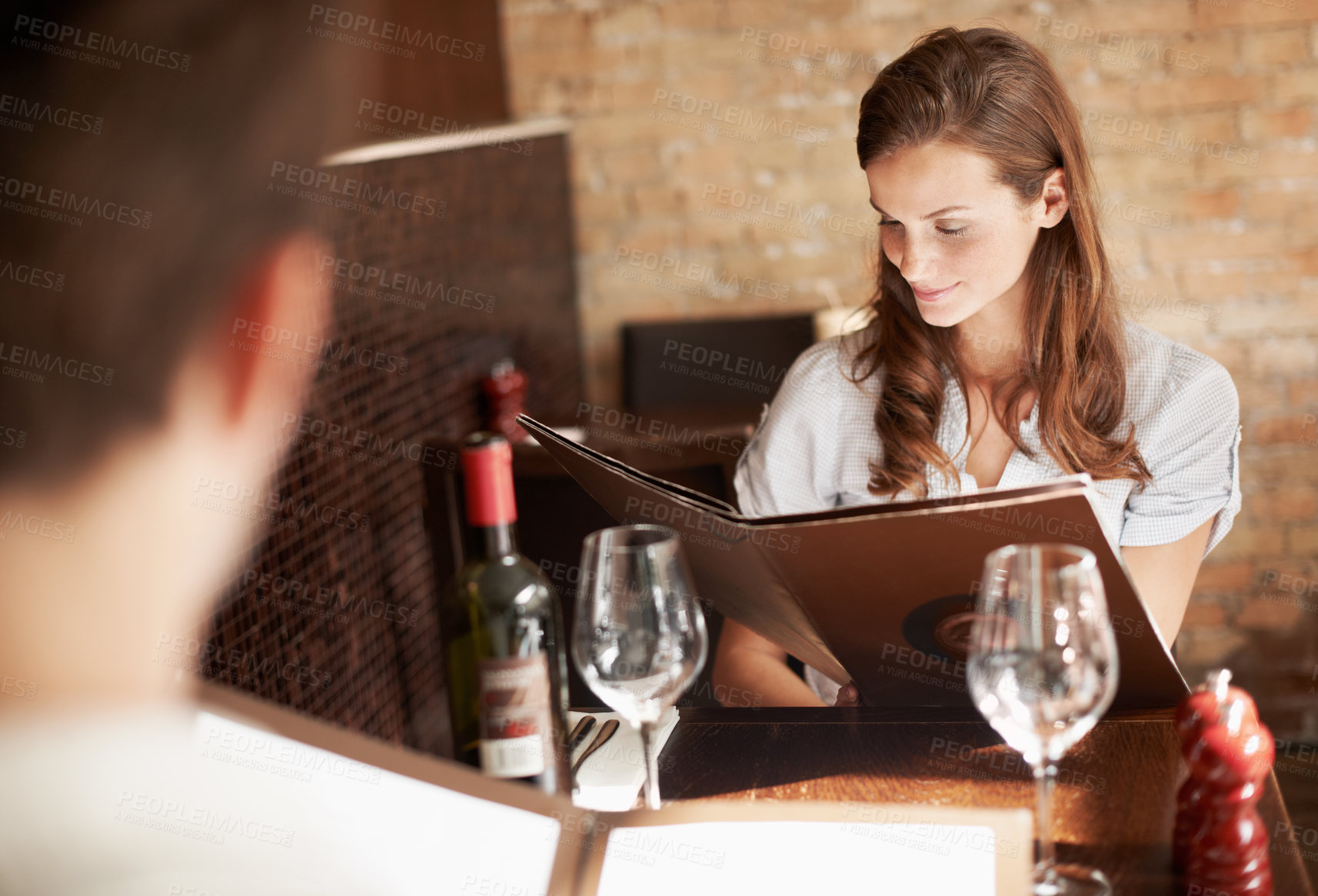Buy stock photo Woman, couple and menu in restaurant with lunch date, meal choice and bonding on weekend break. People, romantic relationship and check dining options with order decision, wine list or relax together