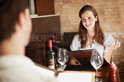 Buy stock photo Woman, couple and conversation in restaurant with menu, meal choice and bonding on weekend break. Happy people, romantic relationship and talk with dining decision, wine list and opinion for cuisine.
