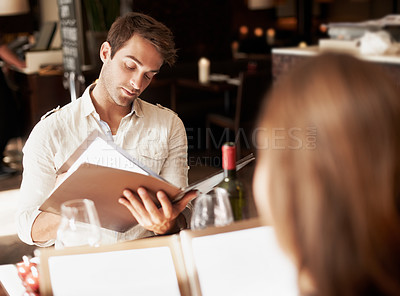 Buy stock photo Man, couple and menu in restaurant with lunch date, meal choice and bonding together on weekend. People, relationship and options in diner with order decision, hospitality or customer experience.