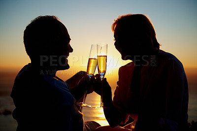 Buy stock photo Couple, sunset and cheers at beach with champagne, celebrate milestone and happy with love. Mature people, marriage and toast with drink for bonding, relationship appreciation and silhouette at ocean