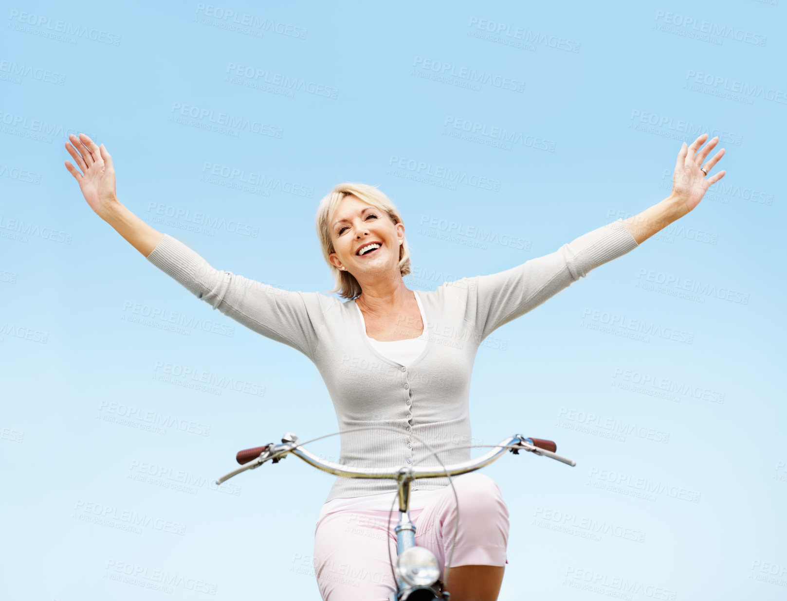 Buy stock photo Sky, freedom and happy woman on bicycle, travel and adventure with eco friendly transport or outdoor. Mockup space, low angle and mature person with smile, cycling and bike with zero carbon emissions