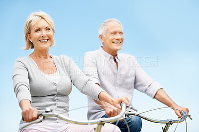 Buy stock photo Love, cycling and happy with old couple in nature for bonding, weekend break and anniversary vacation. Retirement, holiday and travel with senior man and woman on bicycle outdoor for marriage