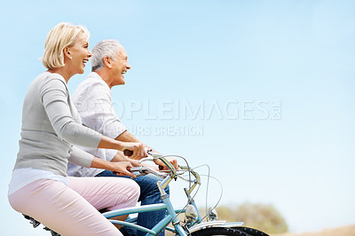 Buy stock photo Love, cycling and space with old couple in nature for bonding, weekend break and anniversary vacation. Retirement, holiday and travel with senior man and woman on bicycle outdoor for marriage
