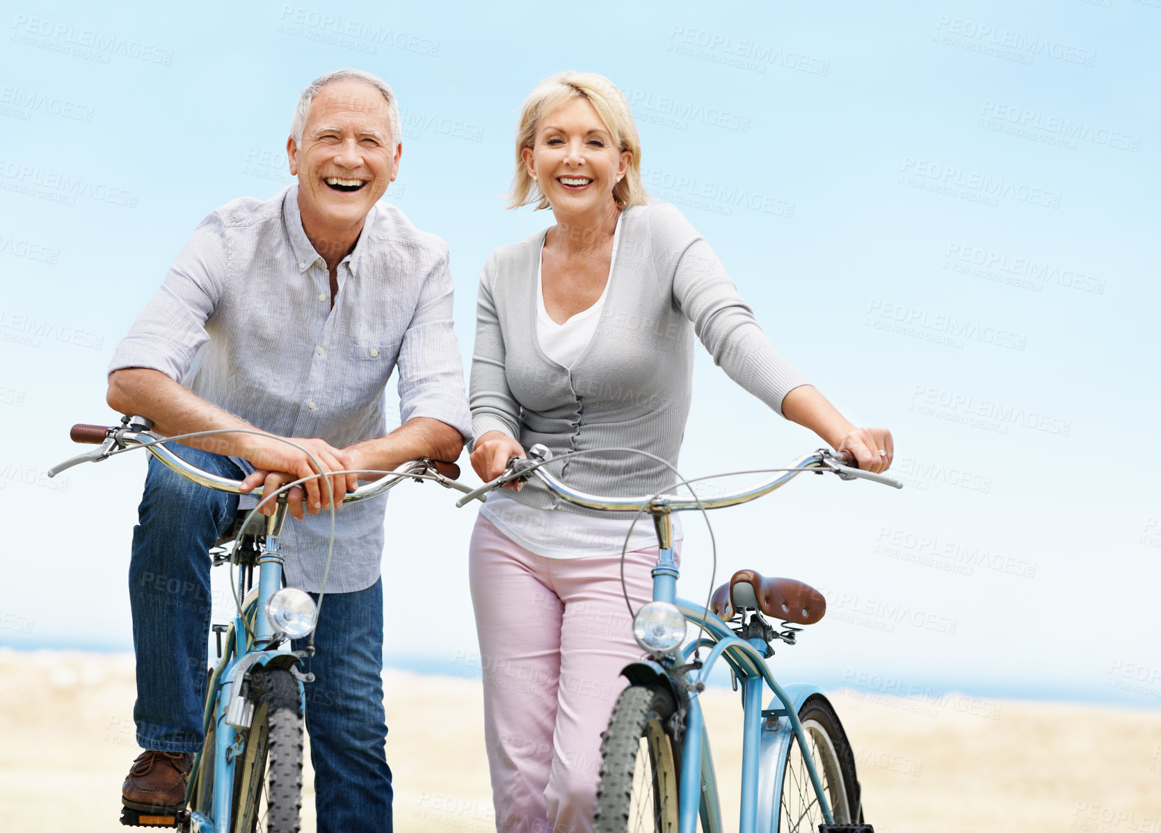 Buy stock photo Beach, bicycle and holiday with senior couple, portrait and laugh with transportation for travel. Happy man, woman and bike outdoor for cycling, health and active retirement for wellness on vacation