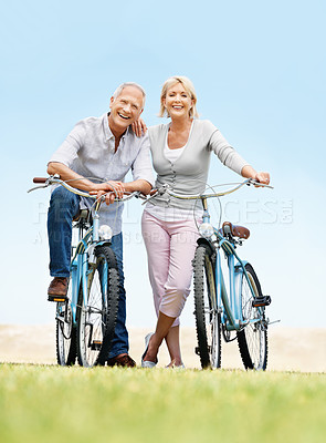 Buy stock photo Portrait, cycling and smile with old couple in nature for bonding, weekend break and anniversary vacation. Retirement, holiday and travel with senior man and woman on bicycle outdoor for marriage