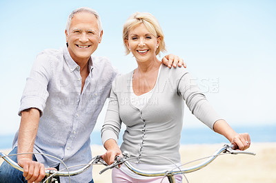 Buy stock photo Beach, bicycle and love with senior couple, portrait and hug with transportation for travel. Happy man, woman and bike outdoor for cycling, connection and active retirement for wellness on vacation