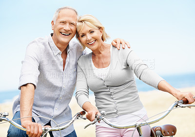Buy stock photo Mature, portrait or happy couple with bicycle in nature for outdoor ride, commute or holiday together. Excited, man and woman with smile on bike for travel weekend, bonding or fun trip in park