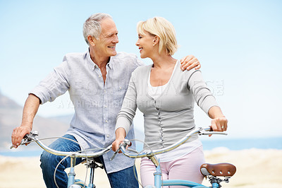Buy stock photo Senior, hug and happy couple with bicycle for outdoor ride, adventure or sightseeing together. Elderly, man and woman with smile or embrace on bike for travel, weekend date or bonding in nature