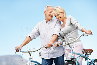 Buy stock photo Outdoor, bicycle and love with senior couple, smile or bonding with partner on vacation. Happy man, woman and bike for cycling to travel, connection and active retirement for wellness on holiday