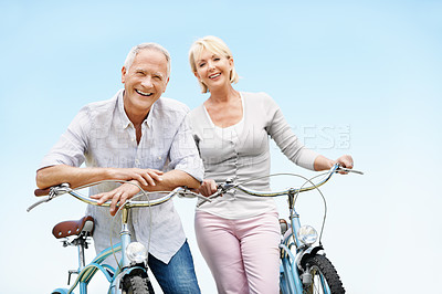 Buy stock photo Blue sky, portrait and senior couple on bicycle outdoor on vacation, getaway or weekend trip together. Smile, break and elderly man with woman on bike for cycling, bonding or adventure on holiday.
