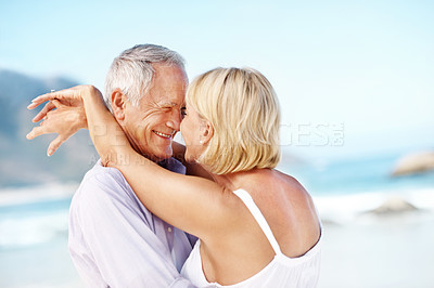 Buy stock photo Holiday, love or elderly couple at beach with hug, happy moment or connection on summer trip. Trust, space or senior people with forehead touch, romantic relationship or bonding on outdoor getaway.