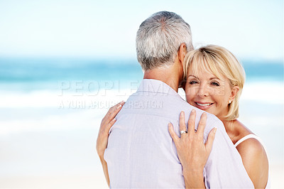 Buy stock photo Happy, hug and portrait of couple by beach on summer vacation, getaway or weekend trip together. Smile, space and mature woman embracing man with safety, bonding or connection by ocean on holiday.