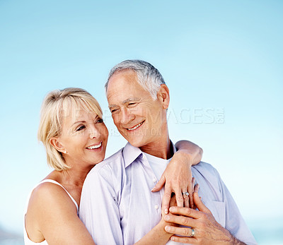 Buy stock photo Happy, hug and couple by blue sky with love on summer vacation, getaway or weekend trip together. Smile, space and mature woman embracing man with safety, bonding or connection in marriage on holiday
