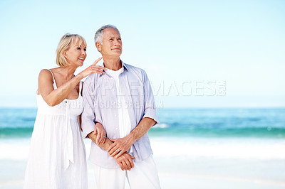 Buy stock photo Mature, couple and point at beach with summer holiday, bonding together and conversation for travel. Space, happy people talk and outdoor by ocean with vacation, tourism and connection for marriage.