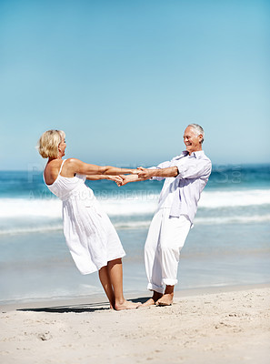 Buy stock photo Holding hands, happy and mature couple at beach for bonding, marriage and playful relationship. Travel, smile and man with woman by ocean for summer holiday, vacation and anniversary for connection