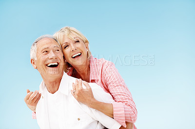 Buy stock photo Blue sky, hug and couple outdoor with happiness, love and affection on vacation together. Smile, space and mature people embracing for connection in marriage on holiday, getaway or weekend trip