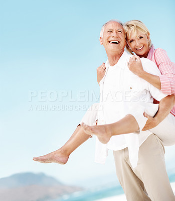 Buy stock photo Holiday, smile or elderly couple at beach with piggyback, bonding or happy moment on trip. Portrait, space or senior people with fun, romantic relationship or playful connection on outdoor getaway.