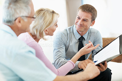 Buy stock photo Elderly couple, document or consulting with financial advisor in home, investment planning or pension. Happy people, wealth advice or paperwork for annuity, asset management or retirement savings