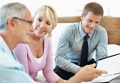 Buy stock photo Document, elderly couple or smile with financial advisor in home, investment planning or pension annuity. Happy people, wealth consultation and paper at house, asset management and retirement savings