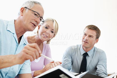 Buy stock photo Notebook, reading and financial advisor with old couple in home for retirement plan, wealth management and profit. Insurance payout, budget and broker with senior man and woman for joint account